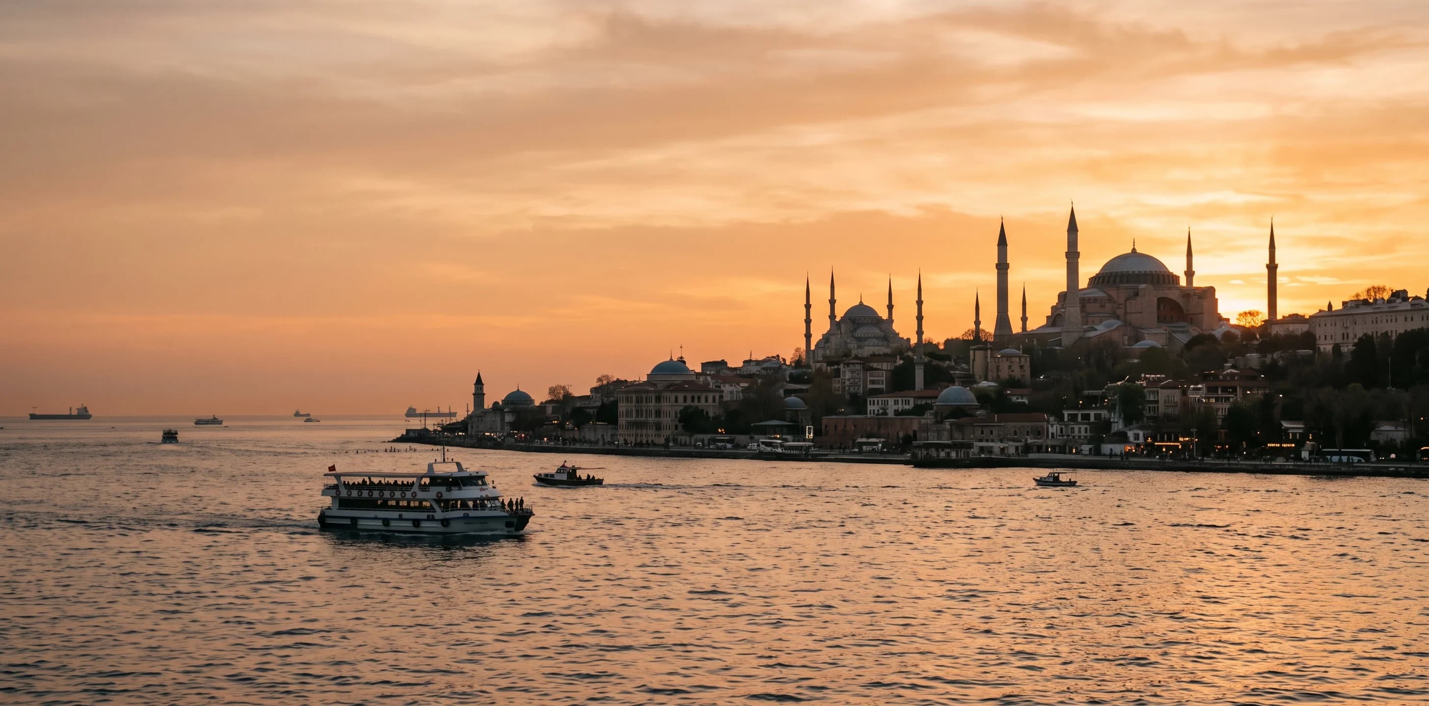 Hagia Sophia and Blue Mosque skyline at sunset over the Bosphorus in Istanbul, Turkey